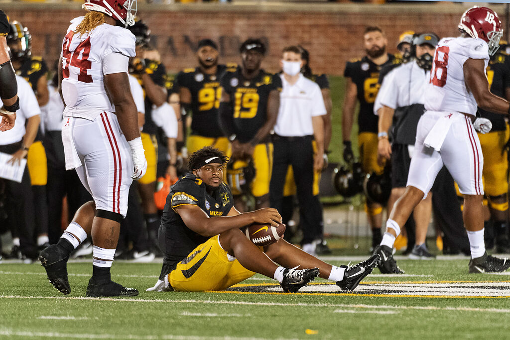 Shawn Robinson sits on the turf